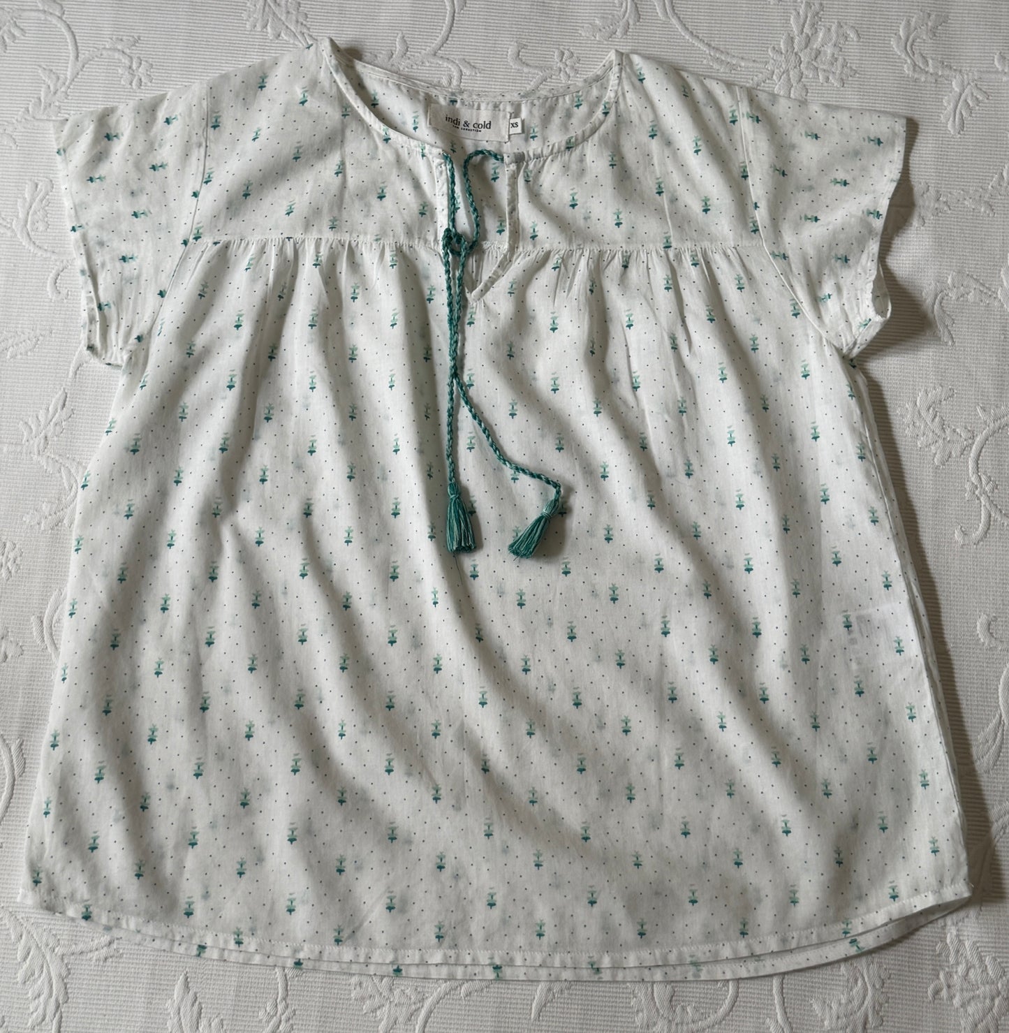 White short-sleeved blouse with green patterns