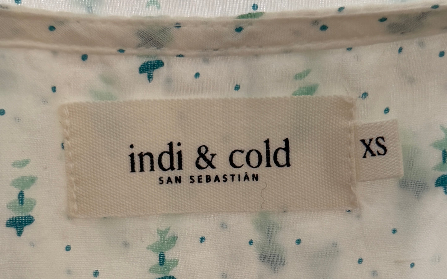White short-sleeved blouse with green patterns