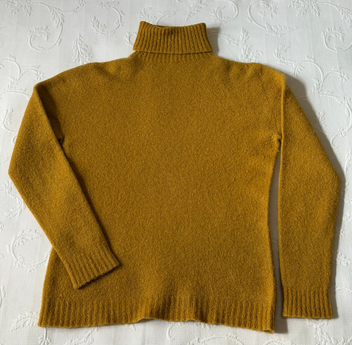 Mustard-colored turtleneck sweater