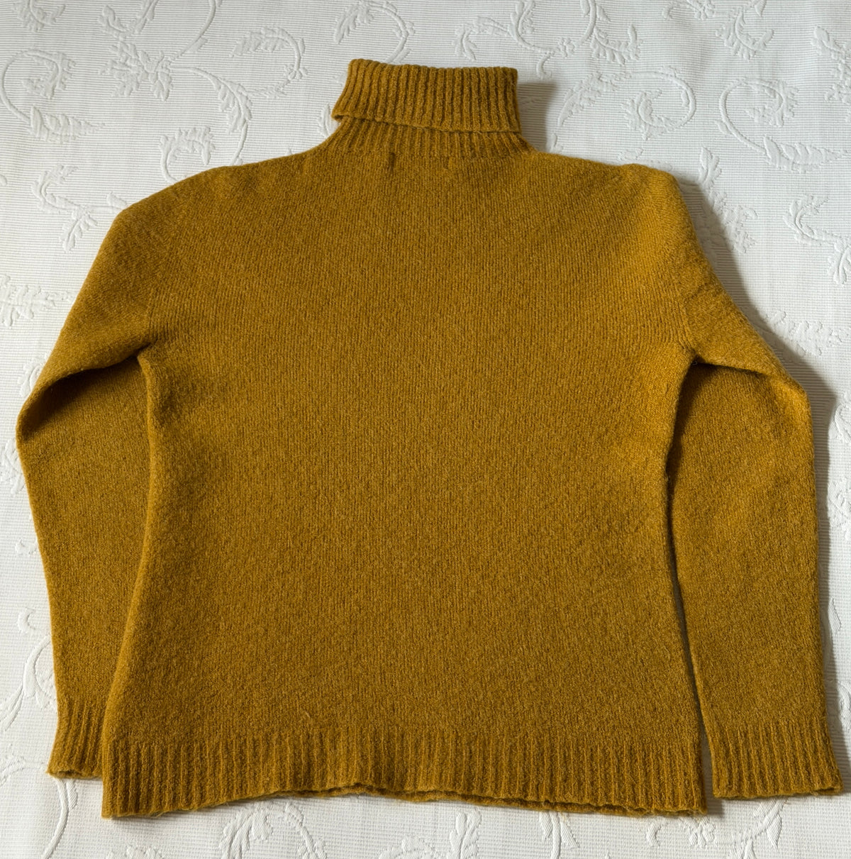 Mustard-colored turtleneck sweater